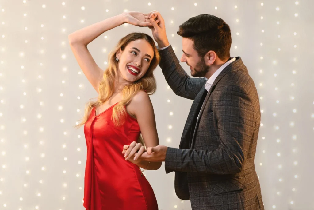 Couple reconnecting during ballroom dance lesson in The Woodlands TX smiling and learning together