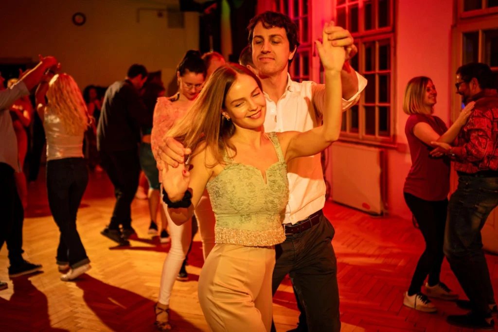 Couple enjoying romantic dance lesson date night in The Woodlands TX smiling and dancing together