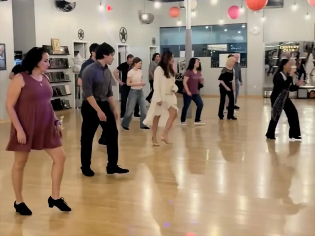 Adult group ballroom dance class with couples learning together at Arthur Murray Dance Studio in The Woodlands TX