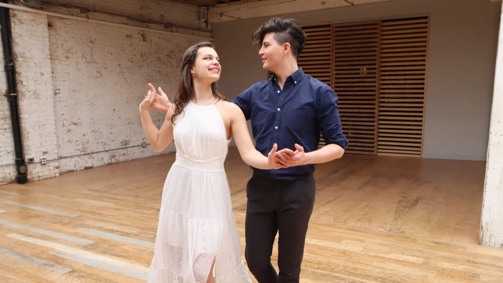 Beginner couple learning ballroom dance steps in a studio in The Woodlands TX