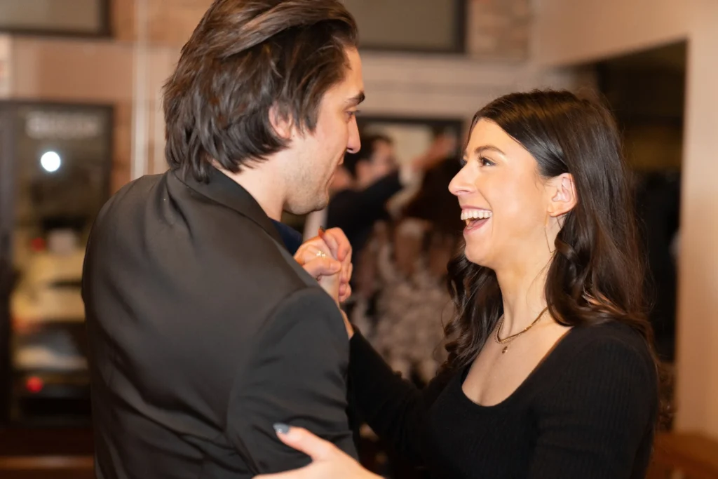 Couple laughing and dancing together during a ballroom dance lesson in The Woodlands TX